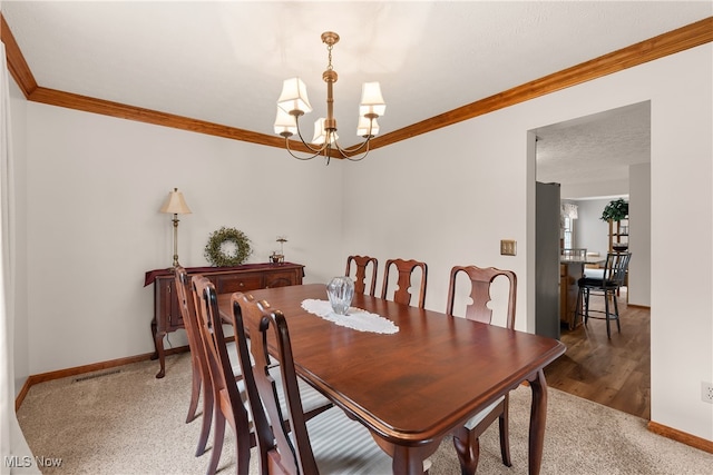 8373 Forest View Dr, Olmsted Falls, OH 44138 - carpeted dining area featuring ornamental molding, a chandelier, baseboards, and wood finished floors
