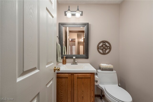 8373 Forest View Dr, Olmsted Falls, OH 44138 - half bath with vanity, toilet, and tile patterned flooring
