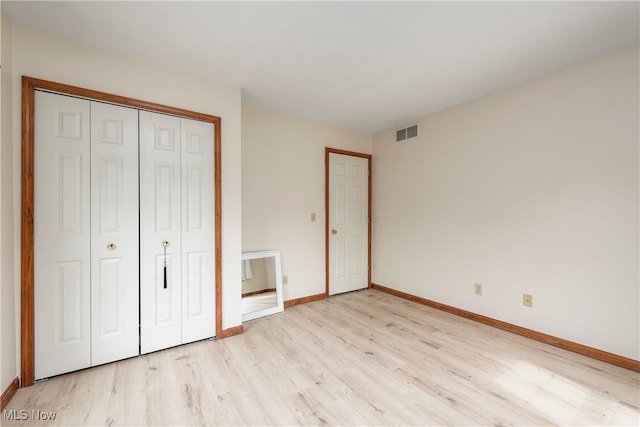 8373 Forest View Dr, Olmsted Falls, OH 44138 - unfurnished bedroom with light wood-style flooring, baseboards, and a closet