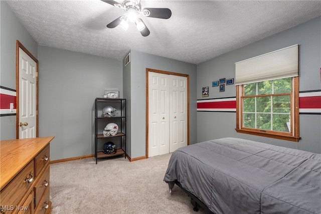 8373 Forest View Dr, Olmsted Falls, OH 44138 - bedroom with light colored carpet, a closet, a textured ceiling, ceiling fan, and baseboards