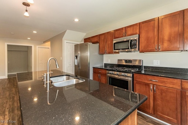 8526 Hoyt Ct, Mentor, OH 44060 - kitchen featuring appliances with stainless steel finishes, a sink, recessed lighting, dark stone countertops, and brown cabinets