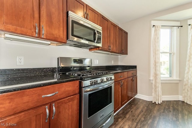 8526 Hoyt Ct, Mentor, OH 44060 - kitchen with stainless steel appliances, dark wood-style flooring, dark stone countertops, baseboards, and brown cabinetry