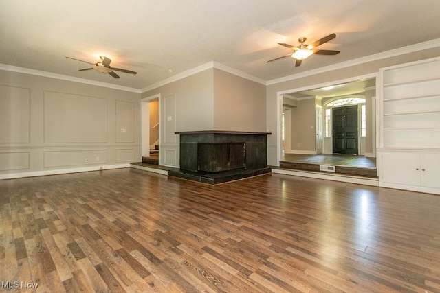 8526 Hoyt Ct, Mentor, OH 44060 - unfurnished living room featuring a ceiling fan, a decorative wall, wood finished floors, ornamental molding, and stairway
