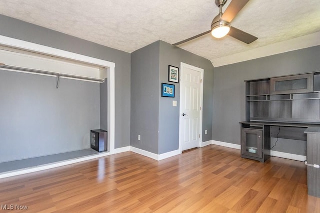 8526 Hoyt Ct, Mentor, OH 44060 - unfurnished living room featuring ceiling fan, wood finished floors, baseboards, and a textured ceiling