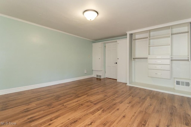 8526 Hoyt Ct, Mentor, OH 44060 - unfurnished bedroom with ornamental molding, wood finished floors, baseboards, and multiple closets
