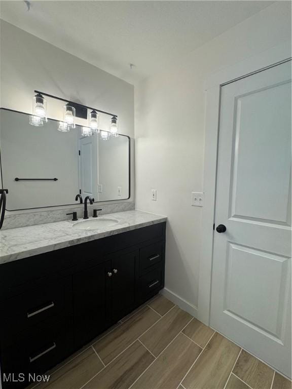 1267 Worton Blvd, Mayfield Heights, OH 44124 - bathroom featuring vanity, wood tiled floors, and baseboards