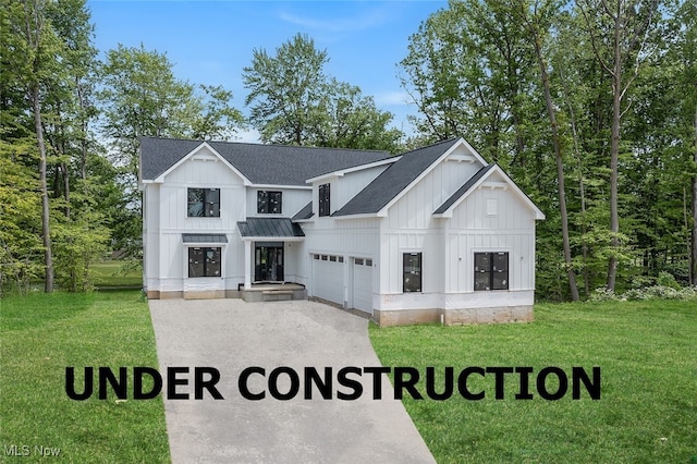 810 Club Dr W, Aurora, OH 44202 - view of front of home featuring board and batten siding, a garage, a shingled roof, and a standing seam roof