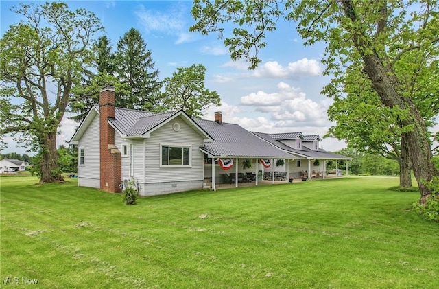 10626 Oakview Dr, Beloit, OH 44609 - back of house featuring a chimney, a lawn, metal roof, and a standing seam roof