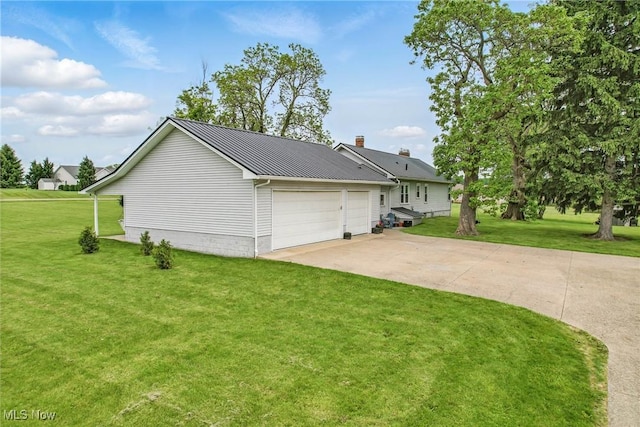 10626 Oakview Dr, Beloit, OH 44609 - view of property exterior with concrete driveway, a lawn, an attached garage, and metal roof