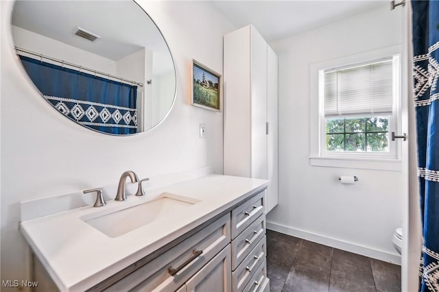 10626 Oakview Dr, Beloit, OH 44609 - full bath with vanity, baseboards, toilet, and tile patterned floors