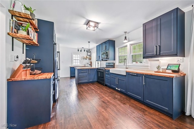 10626 Oakview Dr, Beloit, OH 44609 - kitchen featuring stainless steel appliances, wood counters, a peninsula, blue cabinets, and open shelves