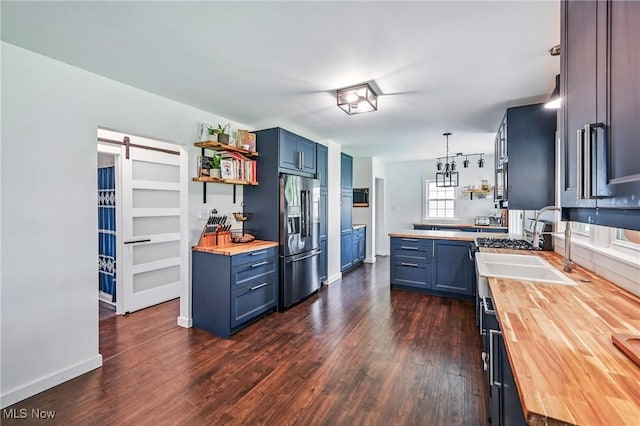 10626 Oakview Dr, Beloit, OH 44609 - kitchen featuring wooden counters, stainless steel fridge, blue cabinetry, and dark wood-style flooring