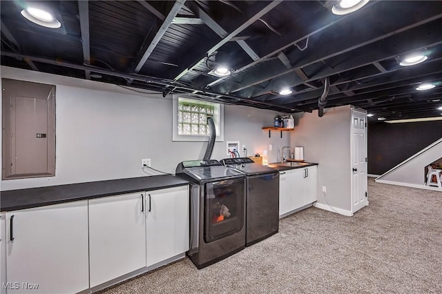10626 Oakview Dr, Beloit, OH 44609 - kitchen with electric panel, washing machine and clothes dryer, light colored carpet, dark countertops, and white cabinetry