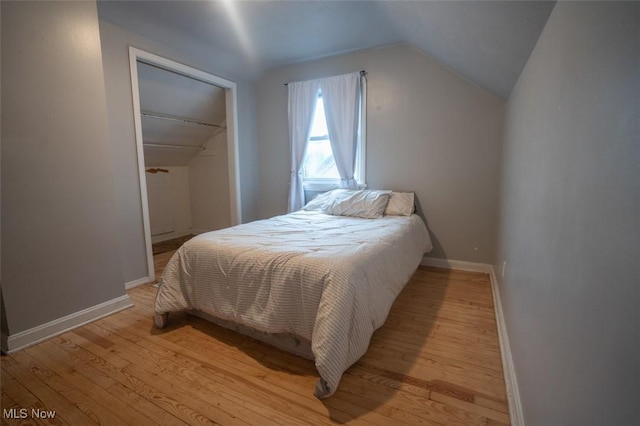 7811 Snow Rd, Parma, OH 44129 - bedroom with lofted ceiling, light wood finished floors, baseboards, and a closet