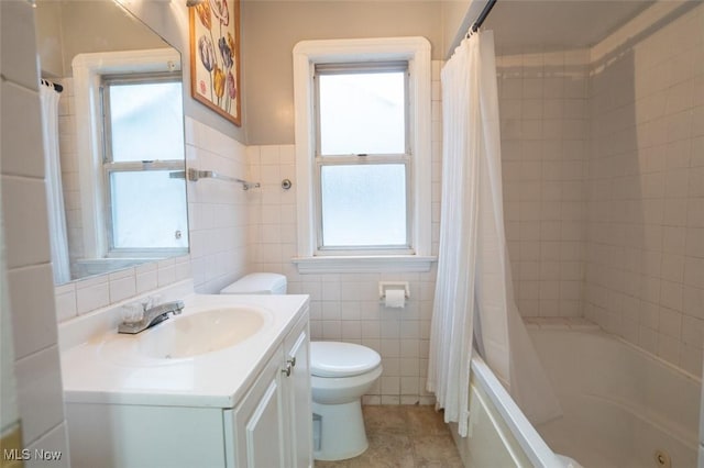 7811 Snow Rd, Parma, OH 44129 - bathroom with plenty of natural light, toilet, tile walls, vanity, and shower / bath combination with curtain
