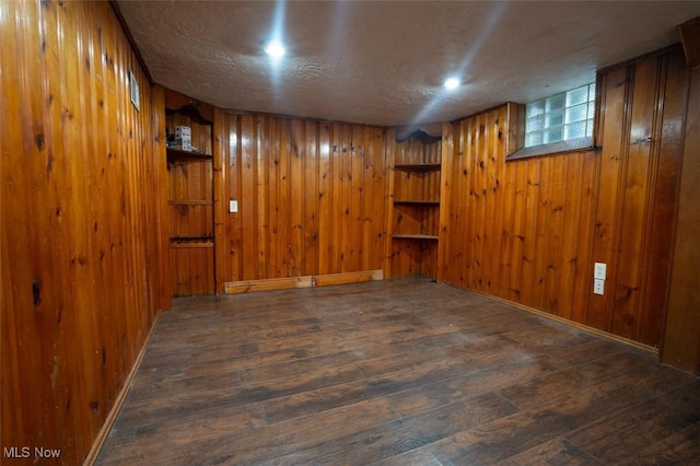 7811 Snow Rd, Parma, OH 44129 - finished basement with hardwood / wood-style flooring, wooden walls, and a textured ceiling
