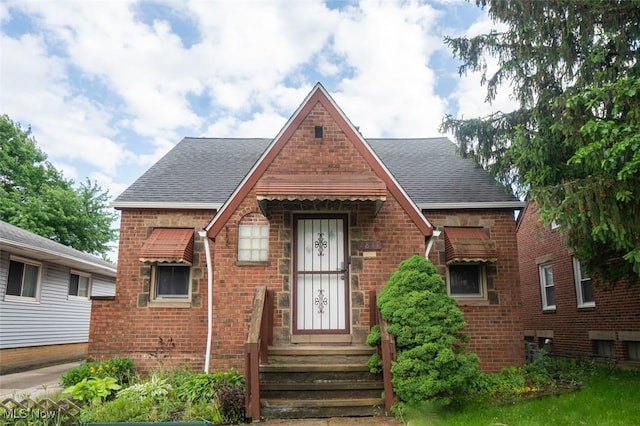 7811 Snow Rd, Parma, OH 44129 - tudor-style house with brick siding and a shingled roof