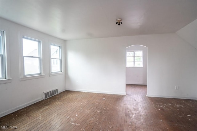 7811 Snow Rd, Parma, OH 44129 - empty room with wood-type flooring, arched walkways, and baseboards
