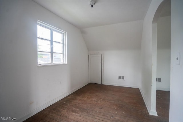 7811 Snow Rd, Parma, OH 44129 - bonus room featuring hardwood / wood-style floors, vaulted ceiling, arched walkways, and baseboards