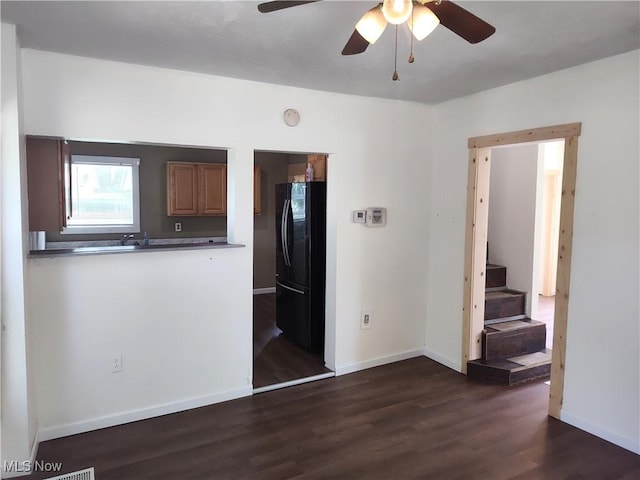 681 Madison St, Conneaut, OH 44030 - spare room with dark wood-type flooring, a ceiling fan, baseboards, and stairway