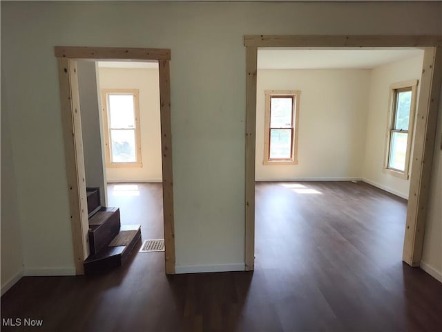 681 Madison St, Conneaut, OH 44030 - spare room with dark wood finished floors, plenty of natural light, and baseboards