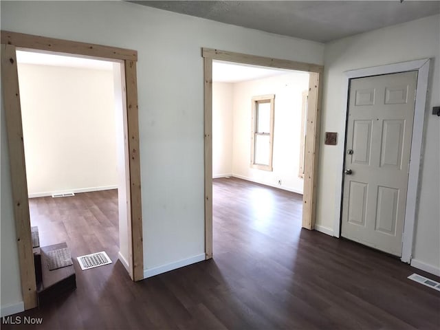 681 Madison St, Conneaut, OH 44030 - foyer entrance featuring dark wood-style floors and baseboards