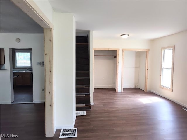 681 Madison St, Conneaut, OH 44030 - unfurnished bedroom with multiple closets, wood finished floors, and baseboards