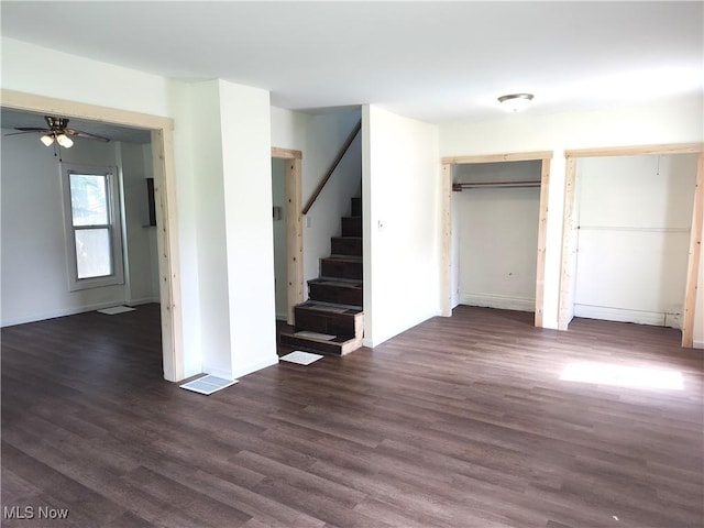681 Madison St, Conneaut, OH 44030 - unfurnished living room featuring stairs, ceiling fan, dark wood-style flooring, and baseboards