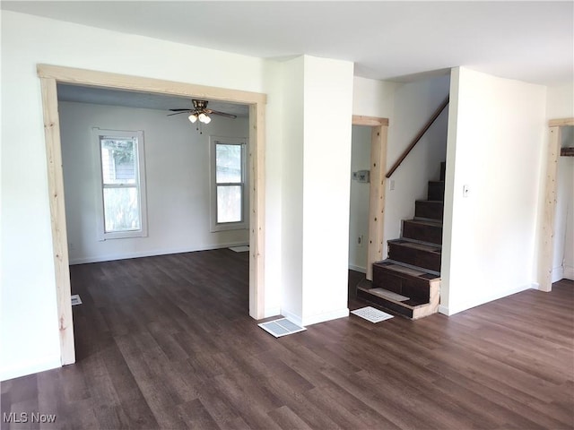 681 Madison St, Conneaut, OH 44030 - unfurnished room featuring dark wood finished floors, stairway, ceiling fan, and baseboards
