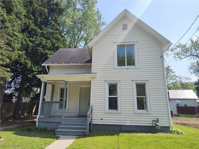 681 Madison St, Conneaut, OH 44030 - view of front of home featuring covered porch, a front lawn, and a shingled roof