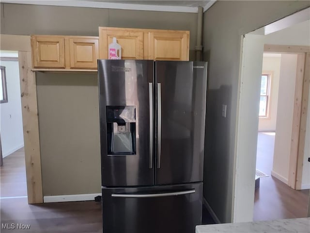 681 Madison St, Conneaut, OH 44030 - kitchen featuring stainless steel fridge with ice dispenser, light brown cabinets, dark wood-type flooring, and baseboards