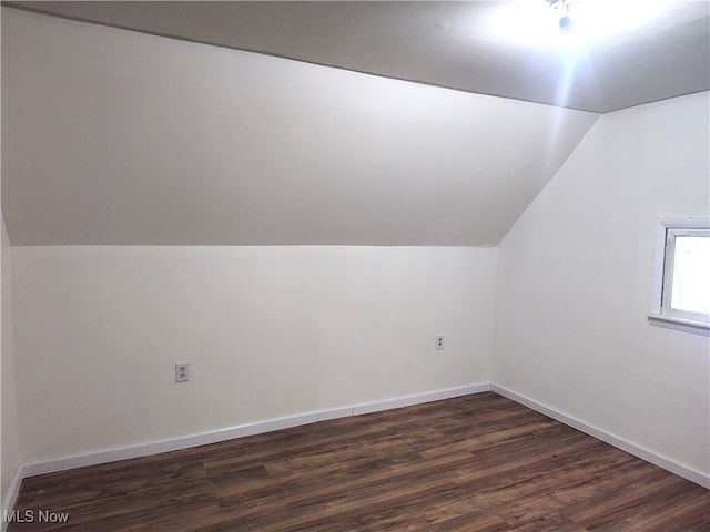 681 Madison St, Conneaut, OH 44030 - additional living space featuring lofted ceiling, dark wood-type flooring, and baseboards