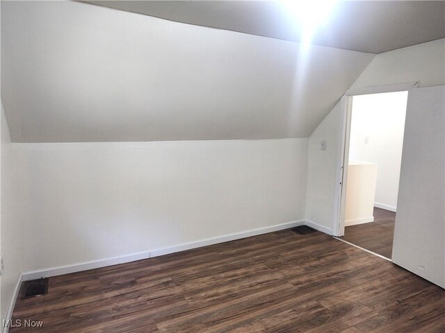 681 Madison St, Conneaut, OH 44030 - bonus room featuring vaulted ceiling, dark wood-style floors, and baseboards