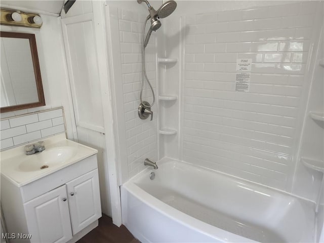 681 Madison St, Conneaut, OH 44030 - bathroom with vanity, bathtub / shower combination, and tasteful backsplash