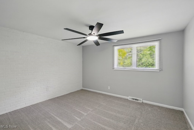8049 Mccreary Rd, Broadview Heights, OH 44147 - empty room with a ceiling fan, brick wall, carpet, and baseboards