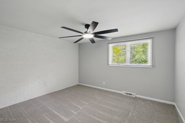 8049 Mccreary Rd, Broadview Heights, OH 44147 - carpeted empty room with ceiling fan and brick wall