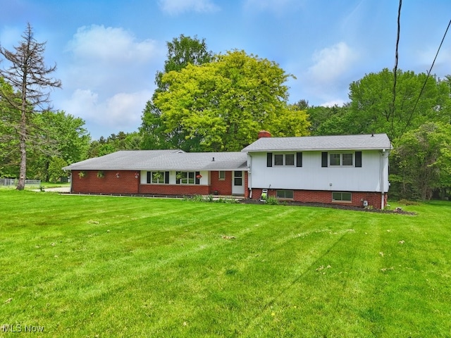 8049 Mccreary Rd, Broadview Heights, OH 44147 - back of property featuring a yard, a chimney, and view of scattered trees