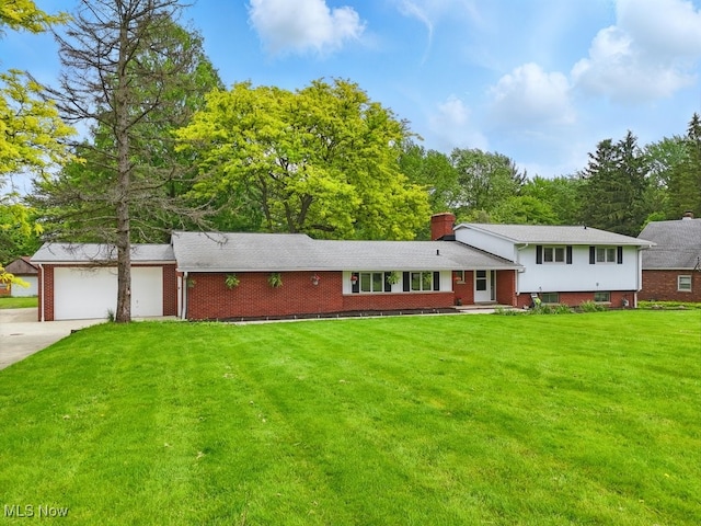 8049 Mccreary Rd, Broadview Heights, OH 44147 - split level home featuring concrete driveway, a front lawn, a garage, brick siding, and a chimney