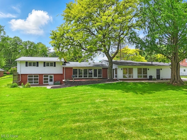 8049 Mccreary Rd, Broadview Heights, OH 44147 - rear view of house featuring brick siding and a yard