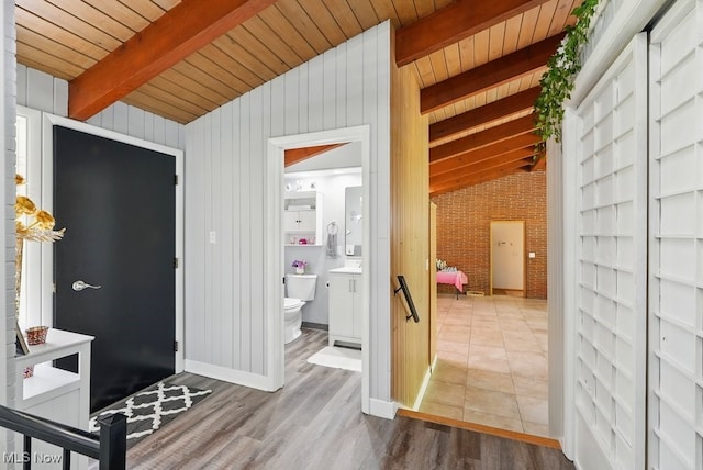 8049 Mccreary Rd, Broadview Heights, OH 44147 - hall featuring wooden ceiling, wood finished floors, and brick wall