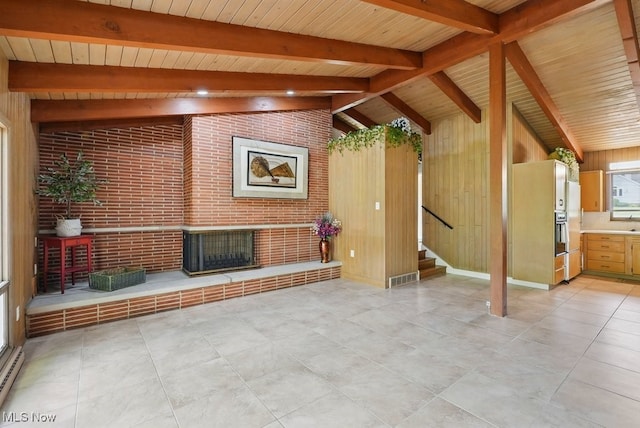 8049 Mccreary Rd, Broadview Heights, OH 44147 - unfurnished living room with stairs, wooden ceiling, wood walls, and brick wall