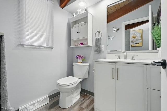 8049 Mccreary Rd, Broadview Heights, OH 44147 - half bathroom with wood finished floors, toilet, and vanity