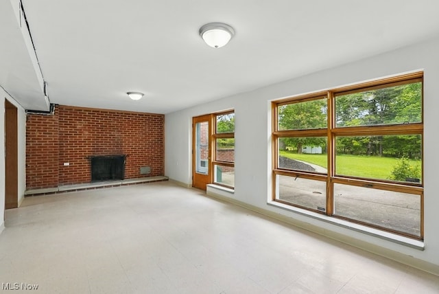 8049 Mccreary Rd, Broadview Heights, OH 44147 - unfurnished living room featuring a brick fireplace, baseboards, and tile patterned floors