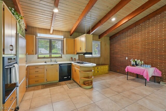 8049 Mccreary Rd, Broadview Heights, OH 44147 - kitchen featuring black dishwasher, stainless steel oven, brick wall, light countertops, and healthy amount of natural light