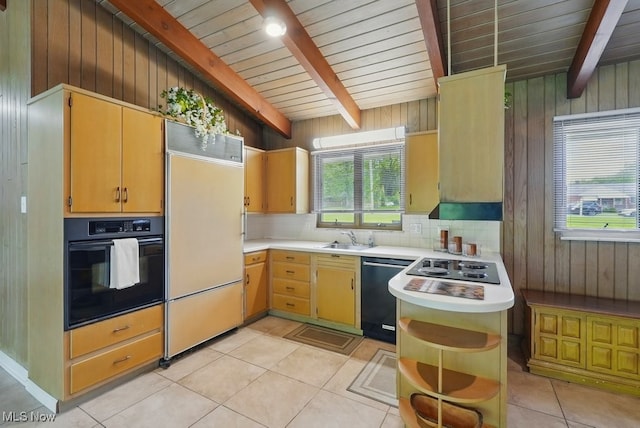 8049 Mccreary Rd, Broadview Heights, OH 44147 - kitchen with black appliances, a sink, light countertops, wood walls, and decorative backsplash
