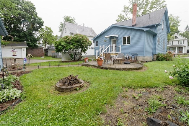 168 Brooklyn Ave, Salem, OH 44460 - rear view of property with a fire pit, a yard, and roof with shingles