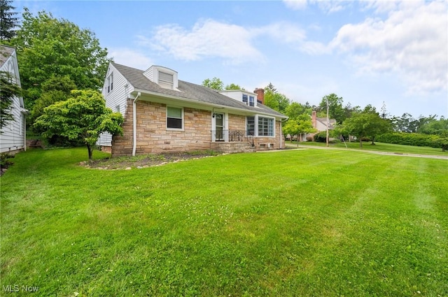 1572 S Belvoir Blvd, South Euclid, OH 44121 - back of house featuring a lawn, stone siding, and a chimney