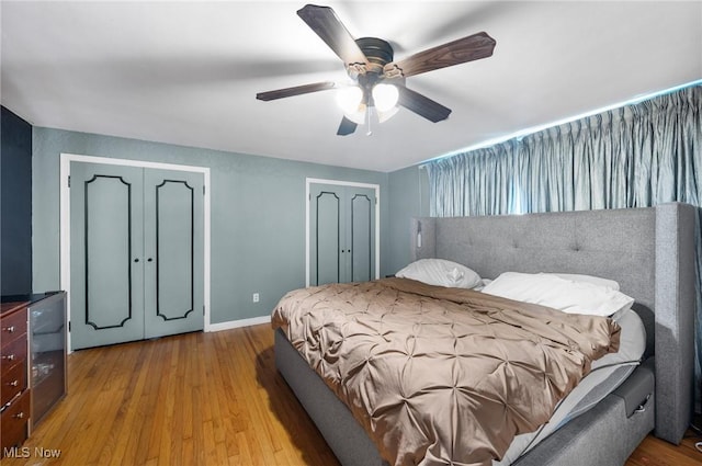 1572 S Belvoir Blvd, South Euclid, OH 44121 - bedroom featuring two closets, wood finished floors, baseboards, and a ceiling fan