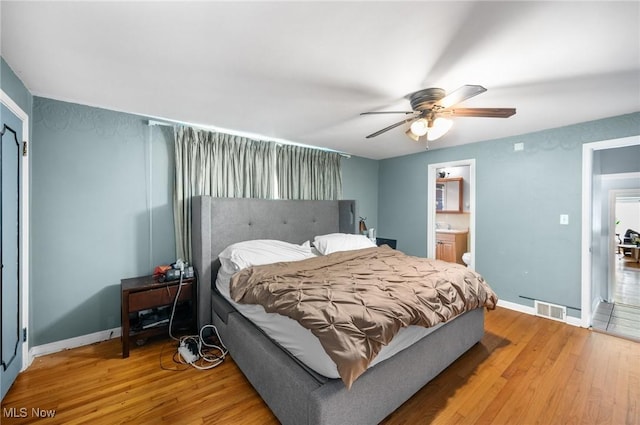 1572 S Belvoir Blvd, South Euclid, OH 44121 - bedroom with light wood-style flooring, baseboards, ceiling fan, and ensuite bathroom