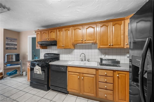 1572 S Belvoir Blvd, South Euclid, OH 44121 - kitchen with black appliances, a sink, under cabinet range hood, tasteful backsplash, and light tile patterned floors